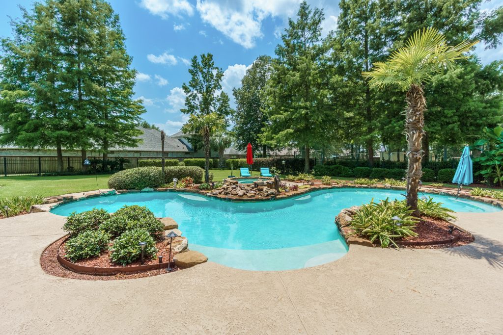 Luxury landscaped pool and hot tub with unique custom design.