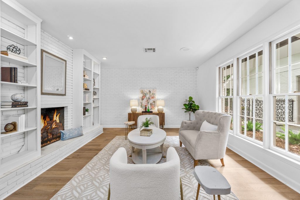 Luxury Keeping area with pass-through fireplace, built-ins, and large windows.