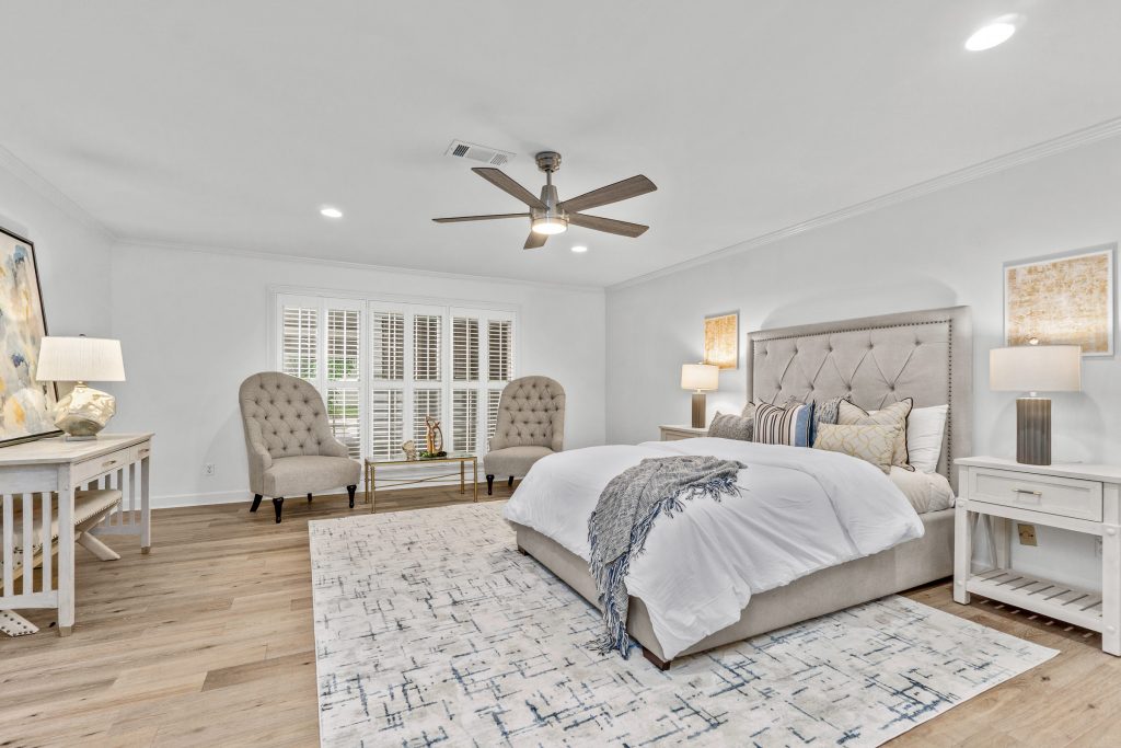 Luxury primary bedroom with natural window light