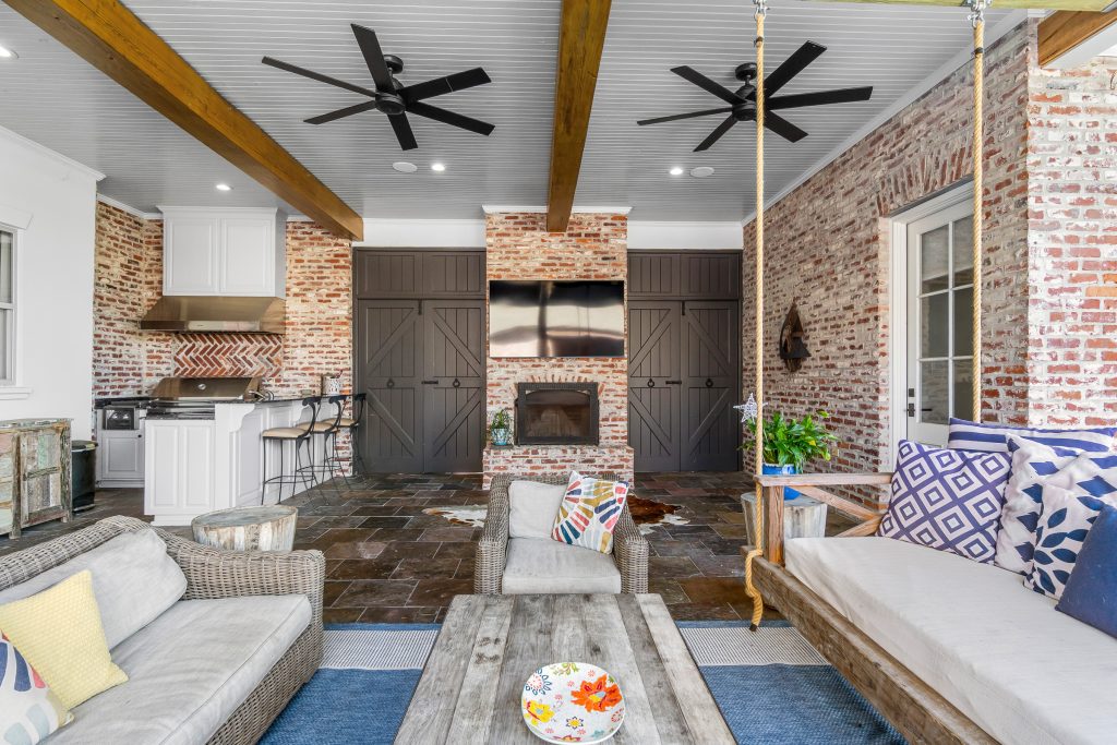 Outdoor seating area leading to a fireplace and outdoor kitchen